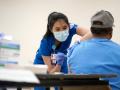 Nurse administering vaccine to patient