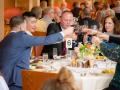 Attendees toast at the dinner.