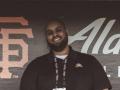 SSU alumnus David Tedla sitting in the San Francisco Giants dugout