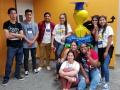 students pose with Woodstock sculpture in library