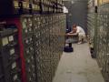 Still from Vanessa Gould's documentary film "Obit." (2016). Journalist looking through cabinets